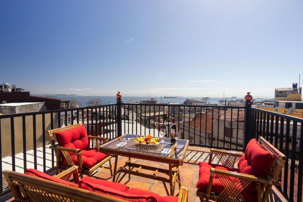 a patio with chairs and a table on a balcony at The First Ottoman Dream in Istanbul