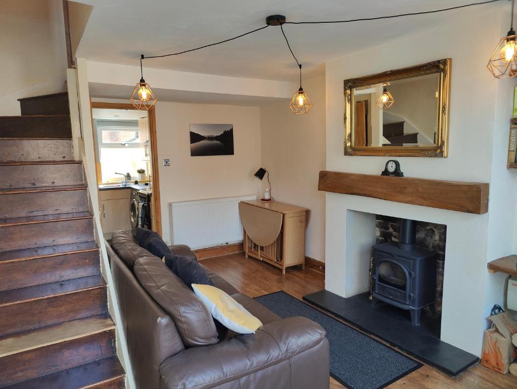 a living room with a couch and a fireplace at Town Centre House with parking in Cheltenham