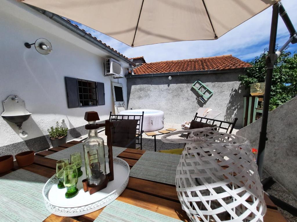 a patio with an umbrella and a table and chairs at Holiday home MILICA in Lovran