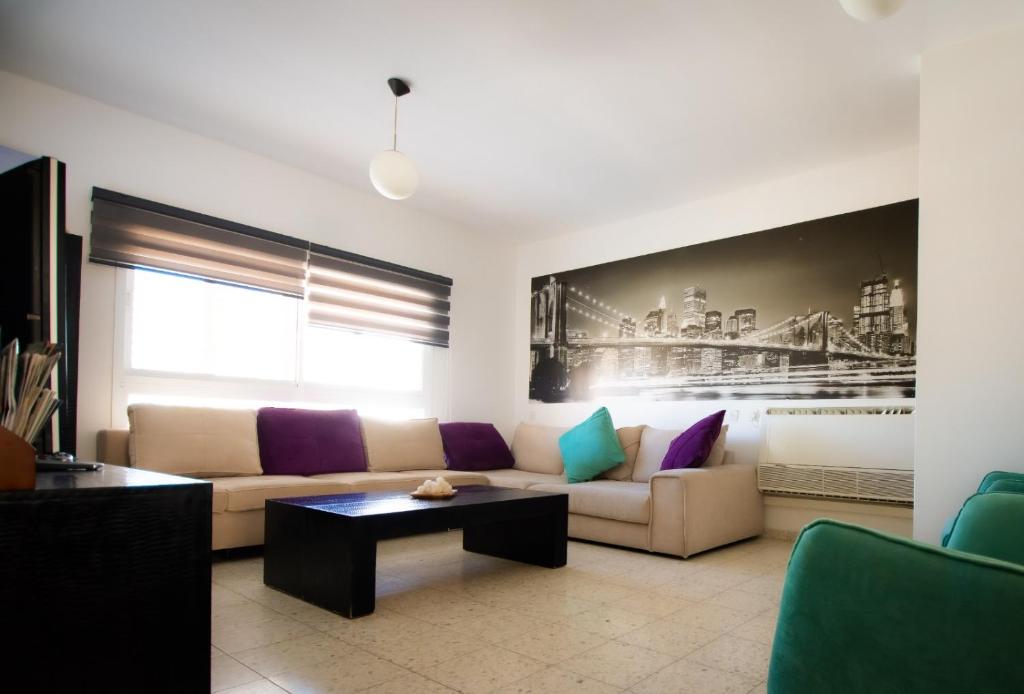 a living room with a couch and a coffee table at Sunlight Holiday Apartment in Arad