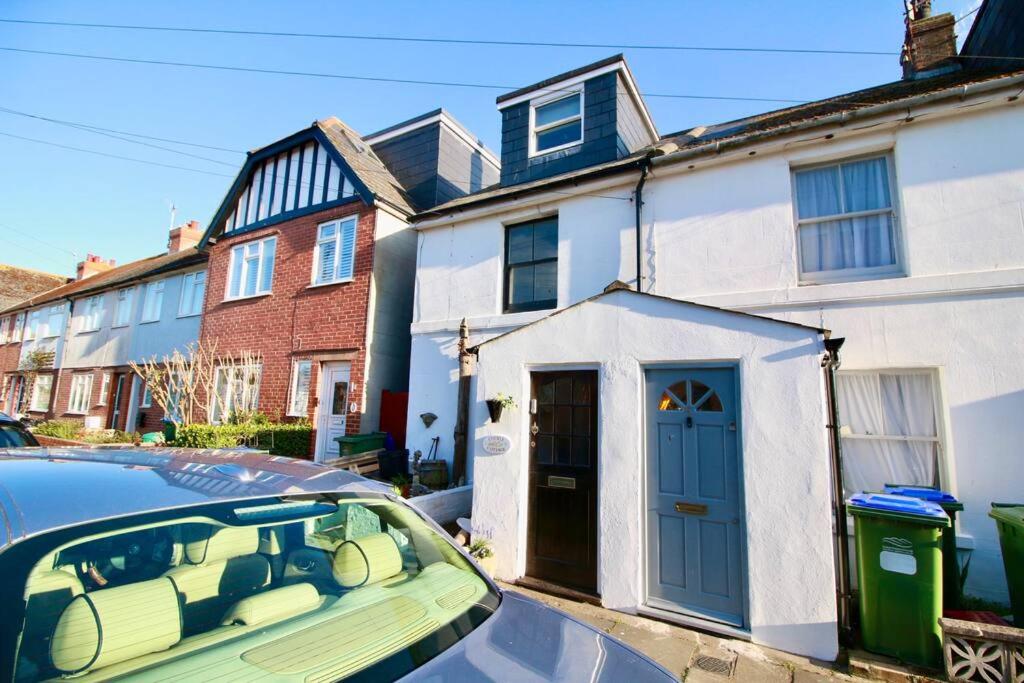 a car parked in front of a house with a blue door at Cockle Cottage, An artists haven, Charming Cottage By Air Premier in Seaford