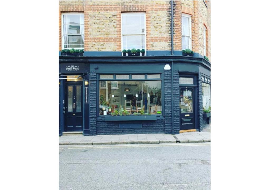 a store front with plants in the window at Driftwood Apartments Broadstairs in Broadstairs