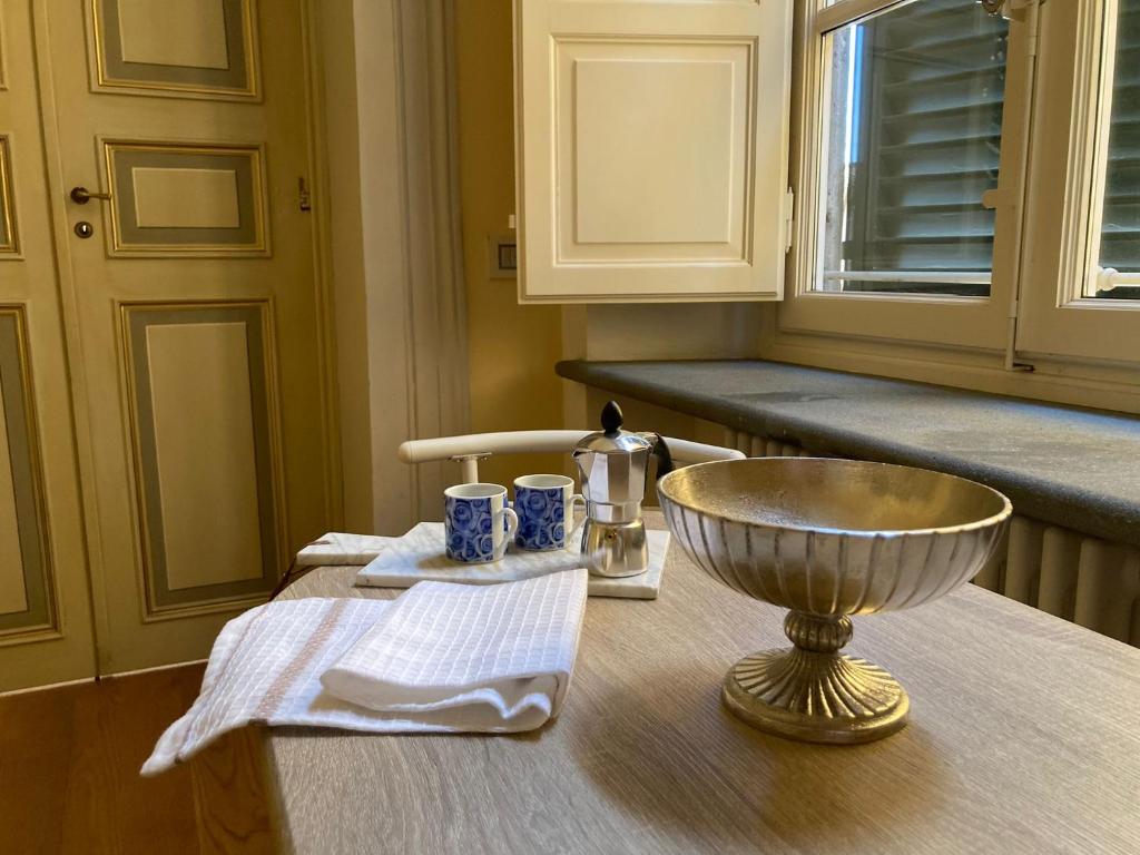 a table in a kitchen with a bowl on it at Puccini's Home, elegant apartment in Piazza Puccini in Lucca
