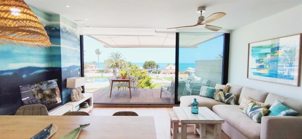 a living room with a couch and a view of the ocean at Apartamento Dénia Beach by DENIA COSTA in Denia