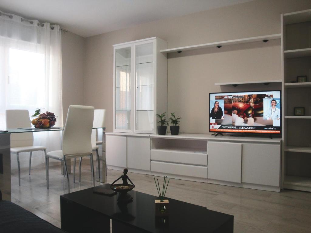a living room with a flat screen tv on a wall at Piso en Alexandre Bóveda in O Grove
