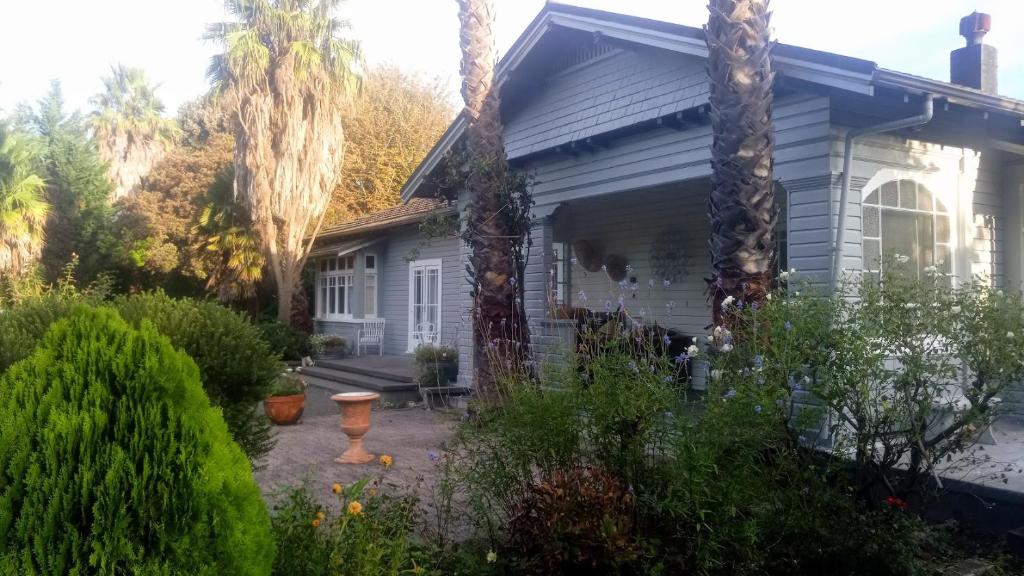 a house with palm trees in the yard at Irongate Retreat in Hastings