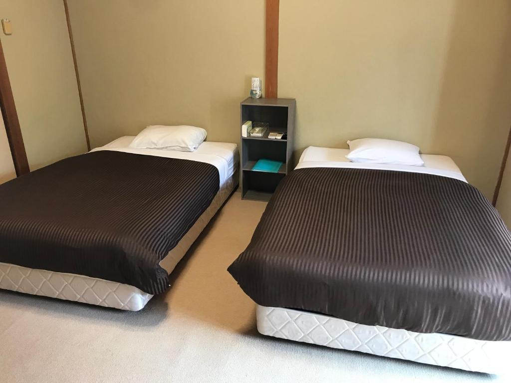 Postel nebo postele na pokoji v ubytování Biz Hotel Kiiyura