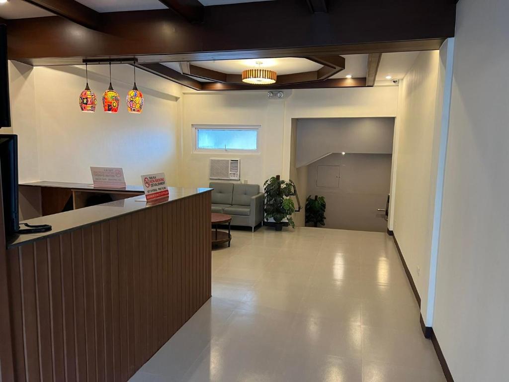 an office lobby with a counter and a waiting room at Traveler's Inn Bajada in Davao City