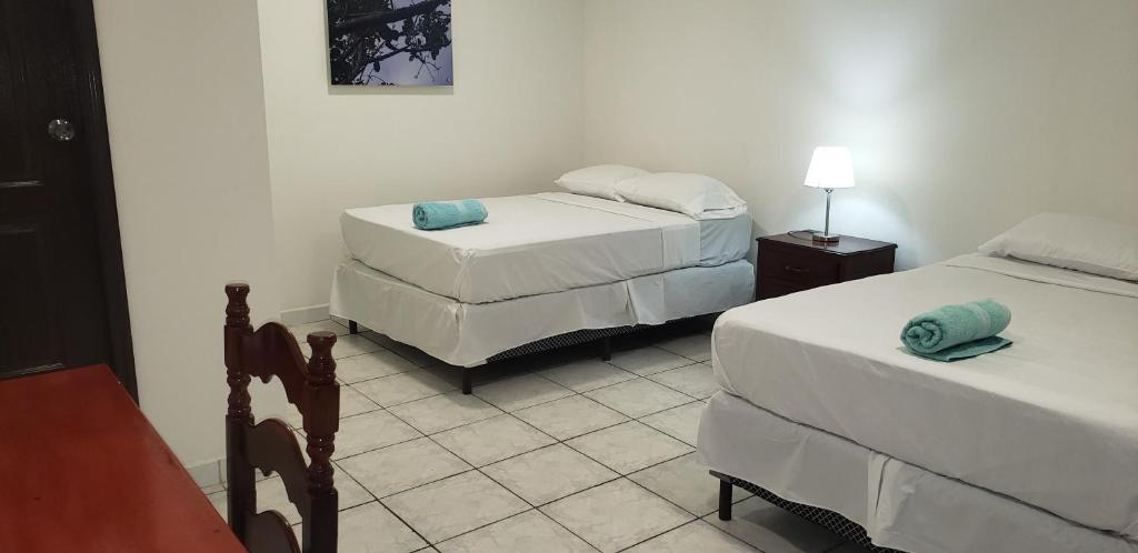 Postel nebo postele na pokoji v ubytování Hotel El Dorado