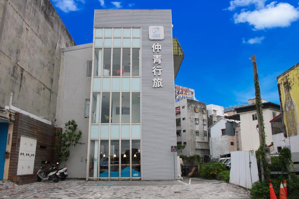 a building with a sign on the side of it at Light Hostel Hualien in Hualien City