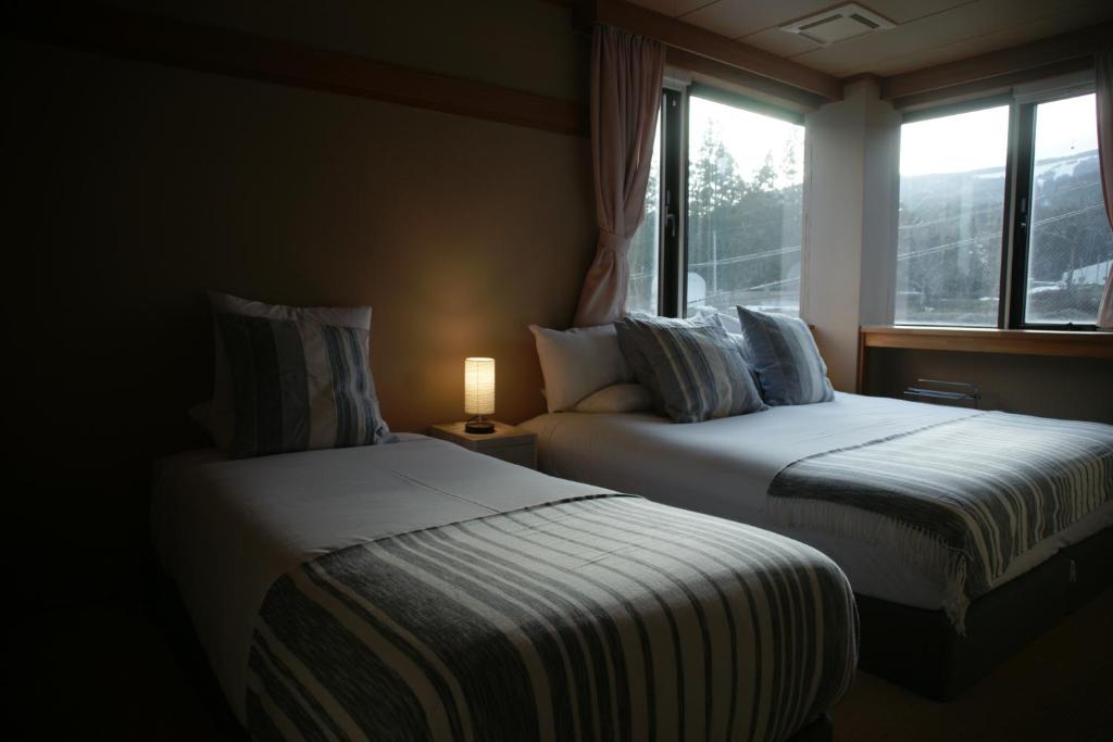 Postel nebo postele na pokoji v ubytování Red Fox Lodge Myoko