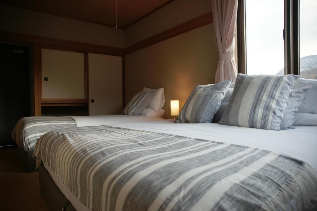 Postel nebo postele na pokoji v ubytování Red Fox Lodge Myoko