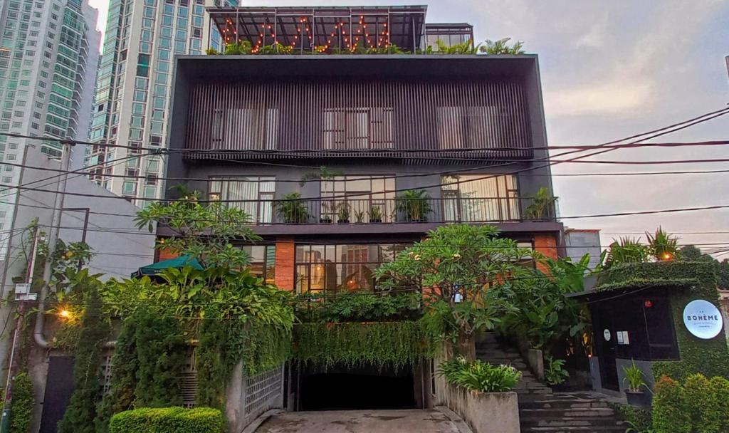 a building with plants on the side of it at La Boheme, Rooms and Coffee in Jakarta