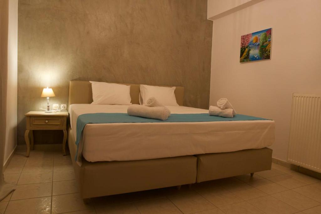 een slaapkamer met een bed met twee handdoeken erop bij Grand House in Agios Nikolaos