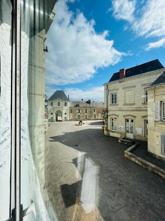a view from a window of an empty street at Chez mimie les hôtes in Fontevraud-l&#39;Abbaye
