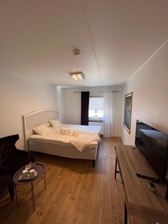a bedroom with a bed and a living room at Saras Hotel FD Amadeus in Ängelholm