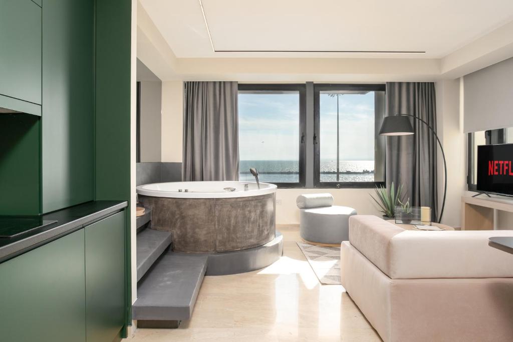 a living room with a tub and a couch at Sea & the City in Thessaloniki