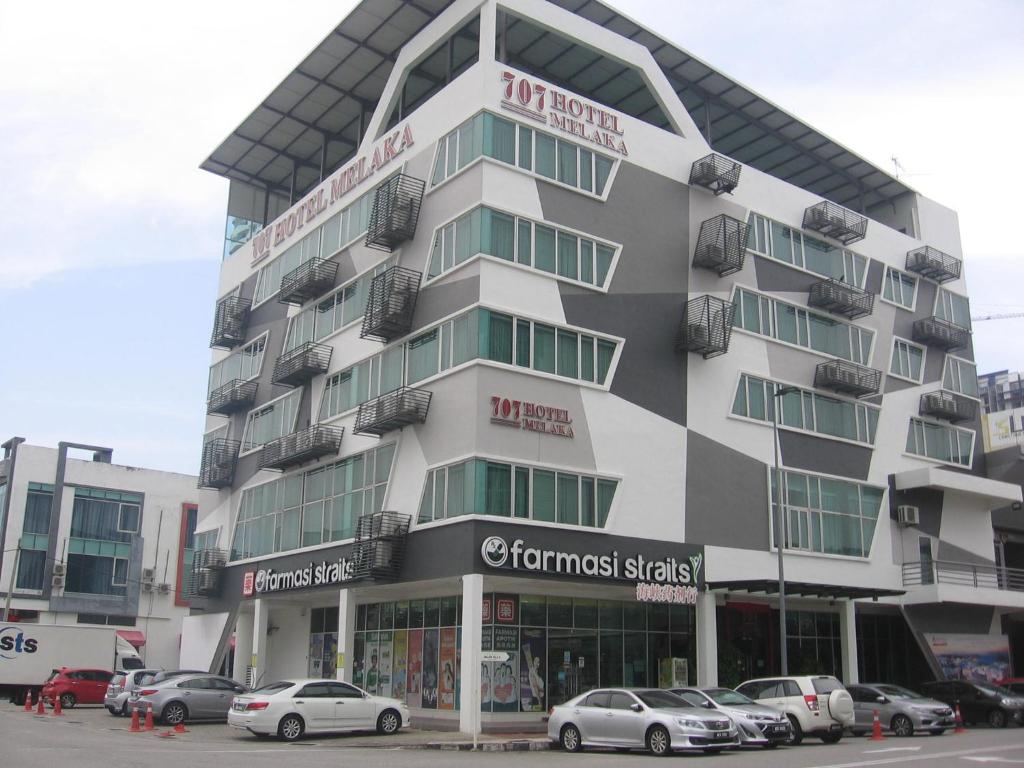 a building with cars parked in front of it at 707 Hotel Melaka (Orange) in Melaka