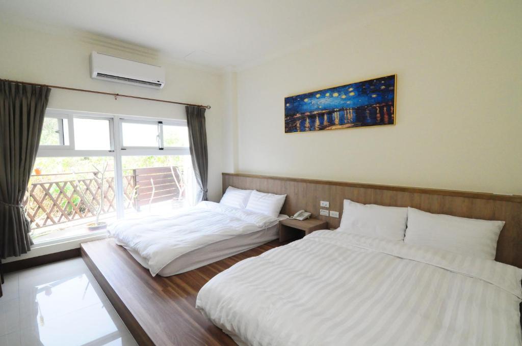 Postel nebo postele na pokoji v ubytování Xinghai Seaview Guesthouse