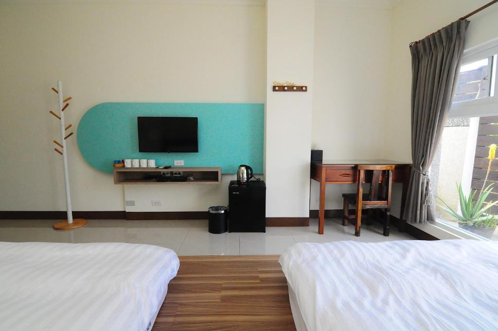 Postel nebo postele na pokoji v ubytování Xinghai Seaview Guesthouse