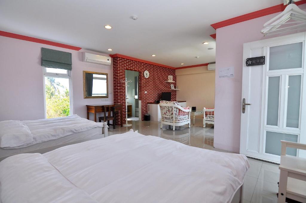 Postel nebo postele na pokoji v ubytování Xinghai Seaview Guesthouse