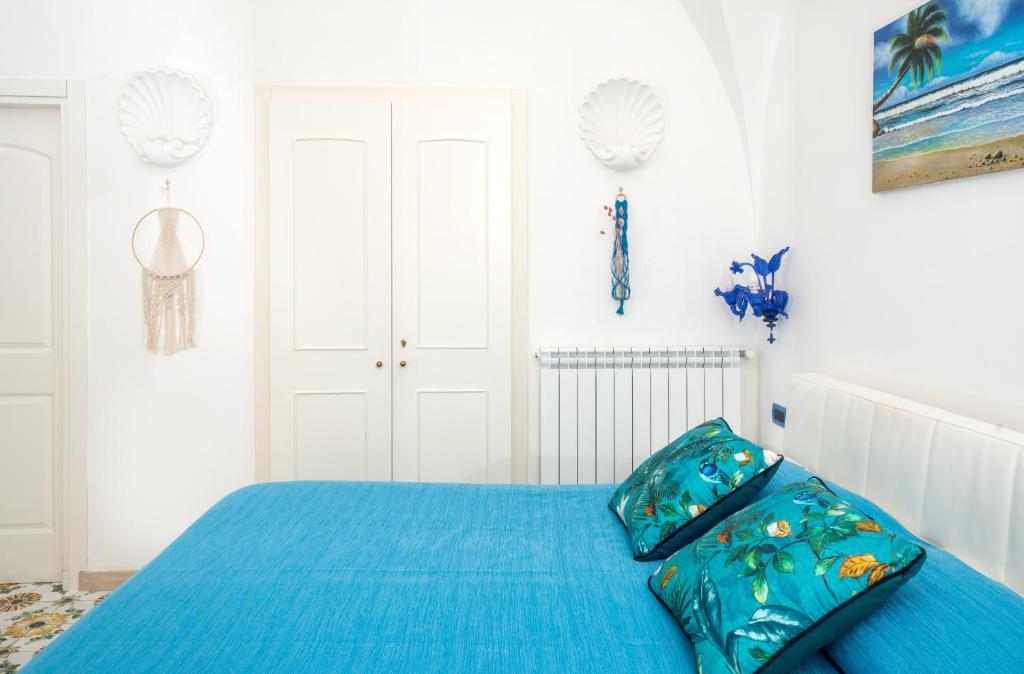 a bedroom with a bed with a blue comforter at B&B Il Sogno in Anacapri