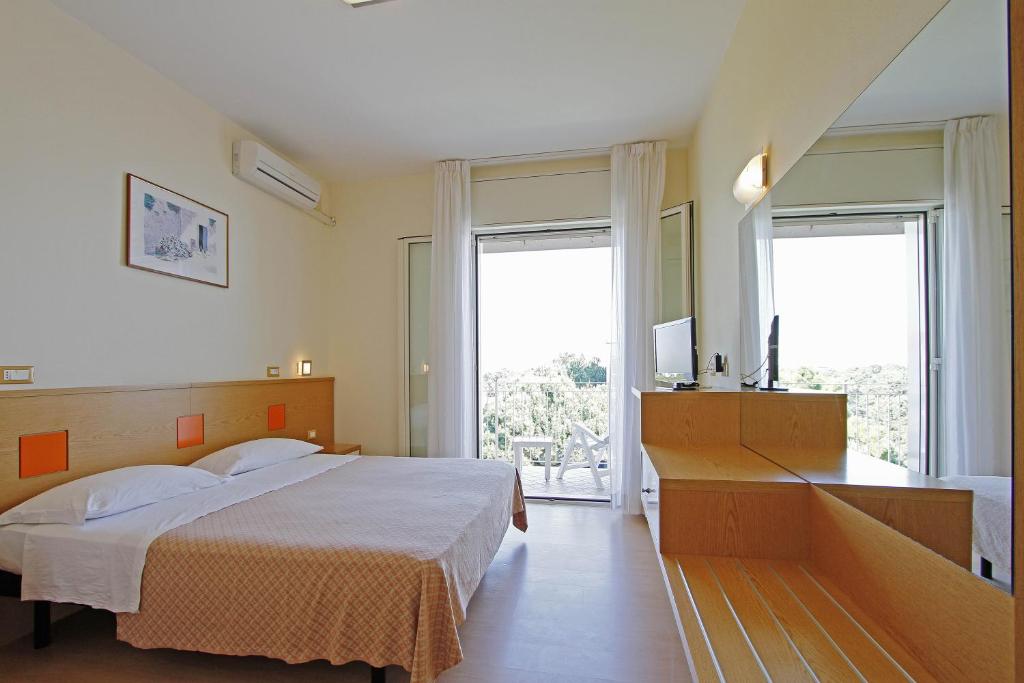 Postel nebo postele na pokoji v ubytování Hotel Ridolfi