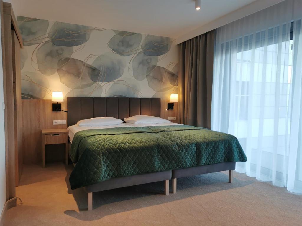 Postel nebo postele na pokoji v ubytování Hotel SKAL Medi SPA & Resort