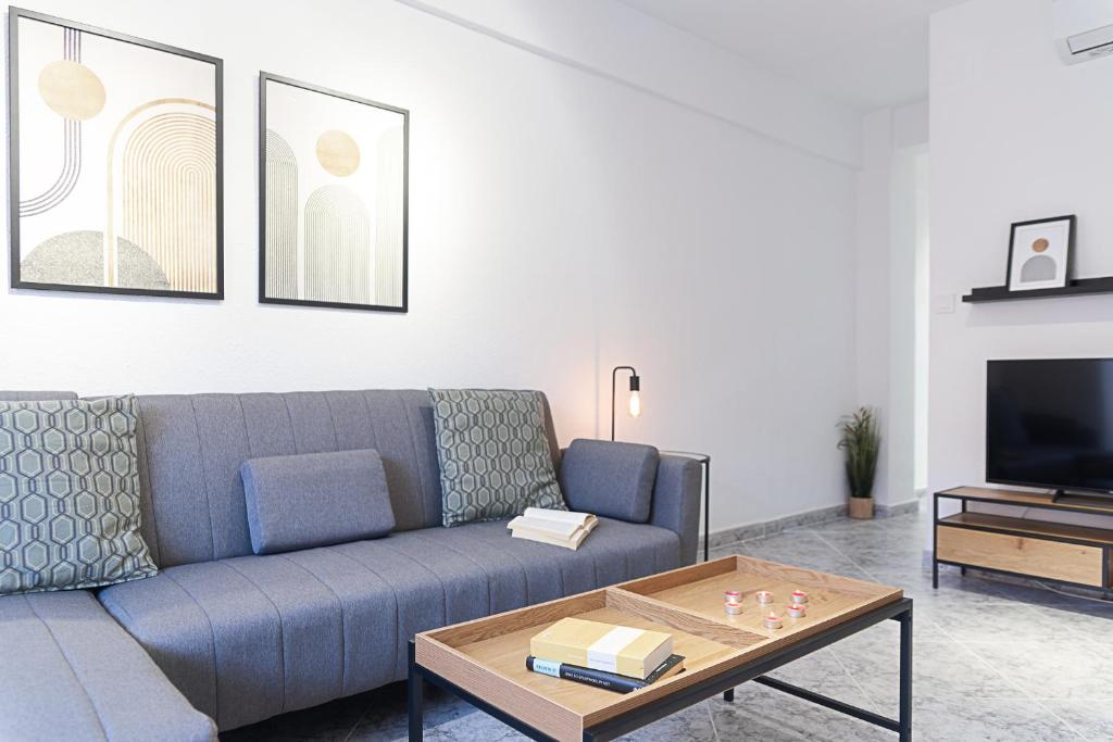 a living room with a couch and a coffee table at Lux&Cool Obispo Orberá - Santa Rita in Almería
