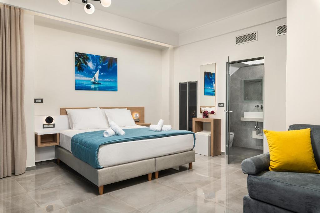 a bedroom with a bed and a couch at Archin Boutique suites in Chania