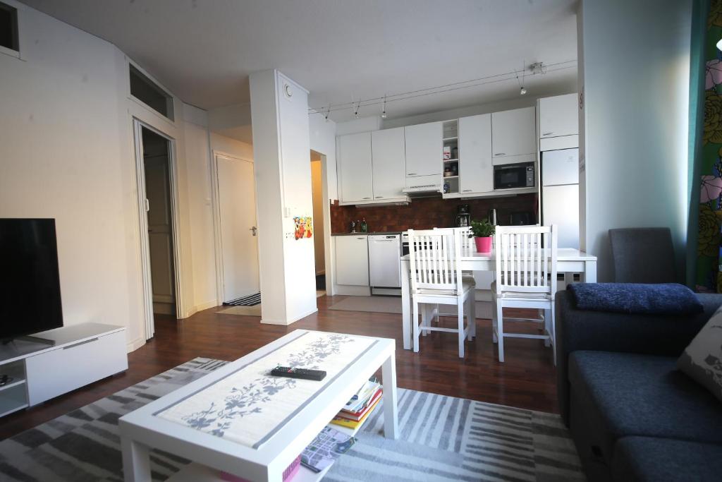 a living room with a couch and a table at Siisti ja kodikas asunnon keskustassa+free parking in Kuopio