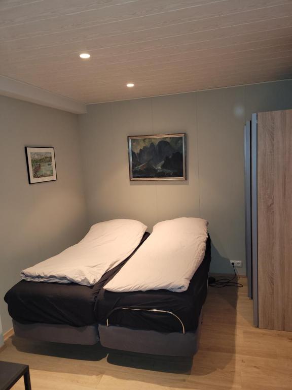 a large bed in a room with at Cozy studio apartment in central Akureyri. in Akureyri