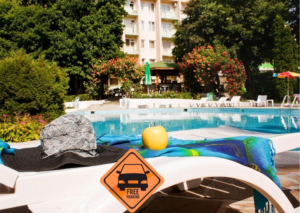 a pool with a sign next to a swimming pool at Ljuljak Hotel - Free Parking in Golden Sands
