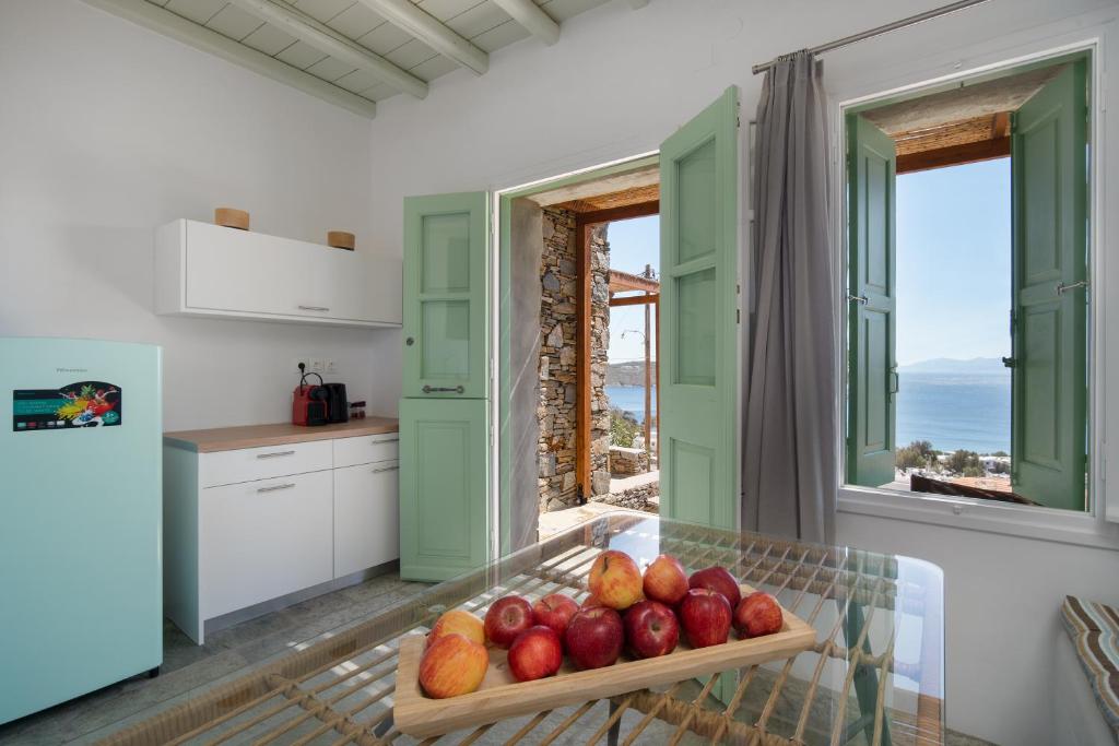 a kitchen with a table with fruit on it at SERIFOS BELLA VISTA 2 in Livadion