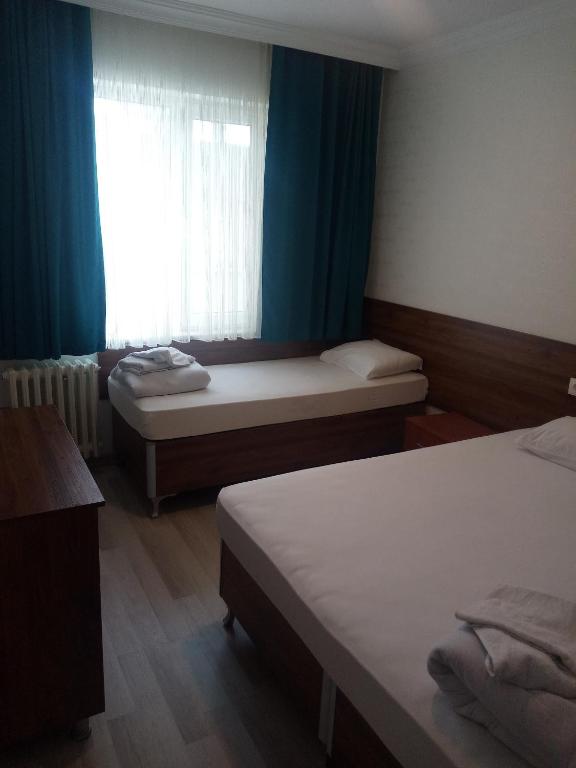 Postel nebo postele na pokoji v ubytování GÜVEN HOTEL