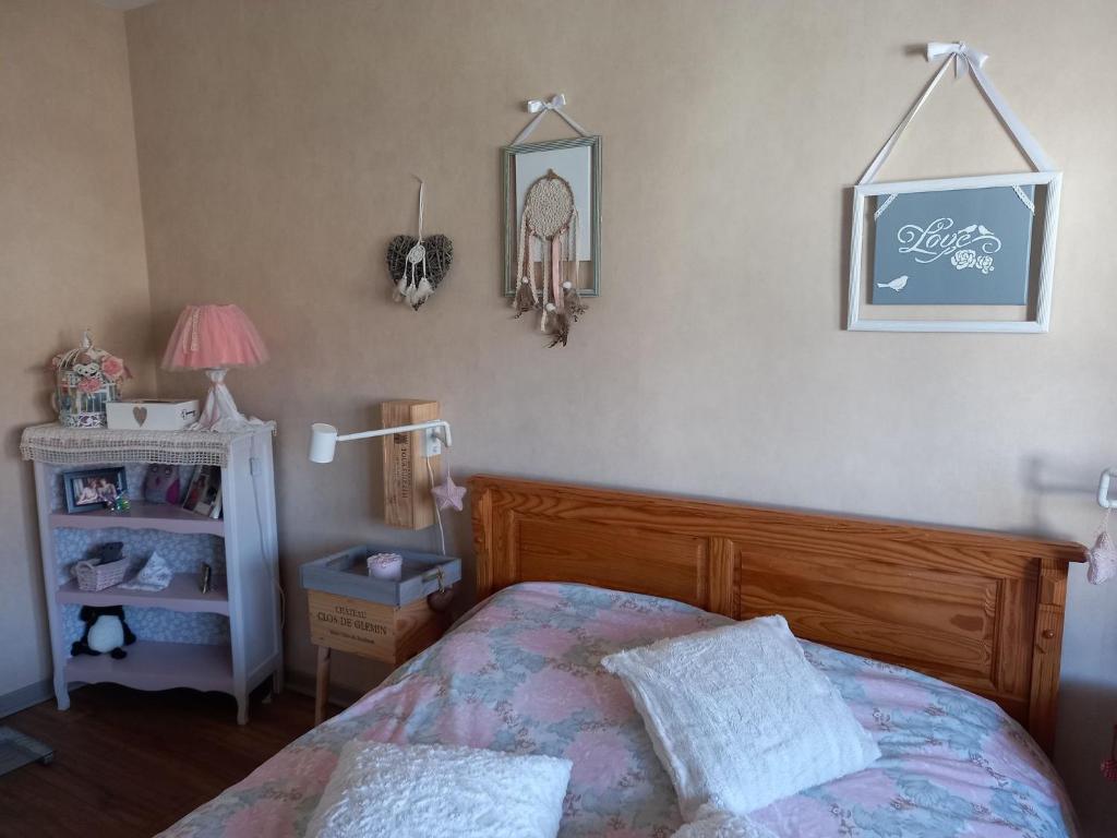a bedroom with a bed and a table with a lamp at Chez Kiki in Épinal