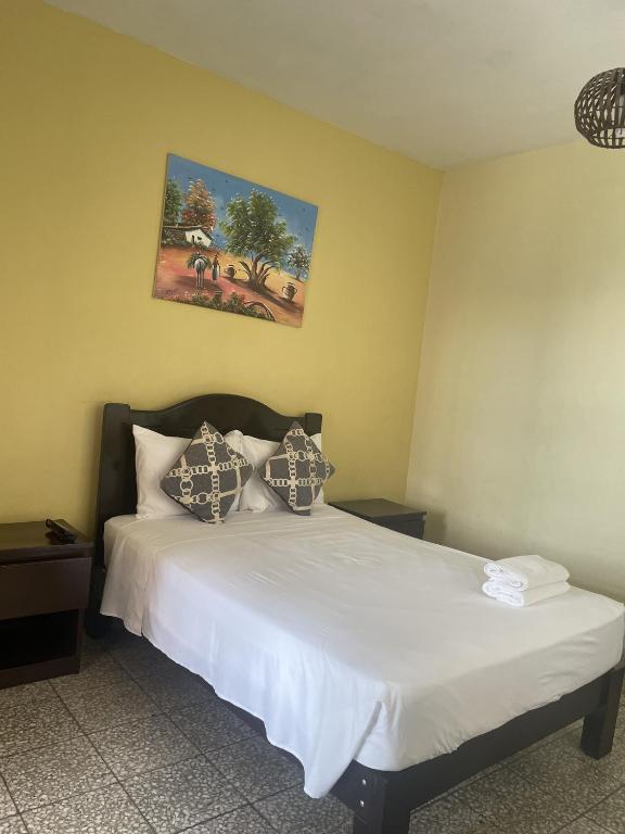 Rúm í herbergi á Hotel Calmelia