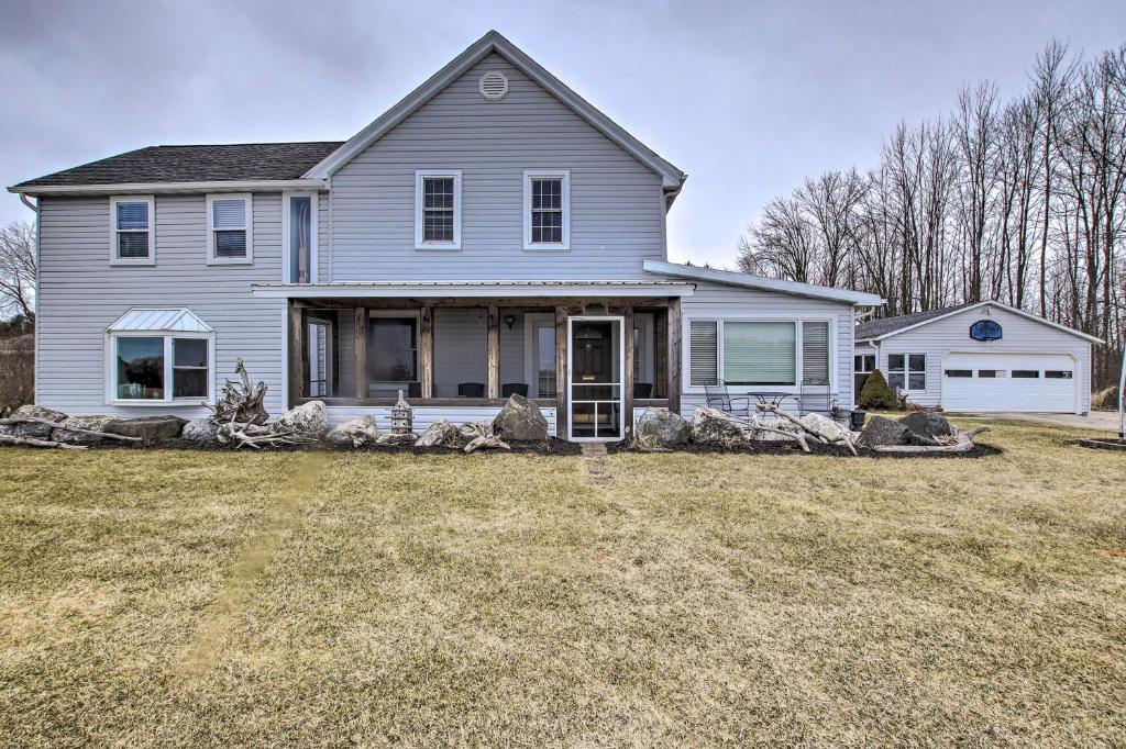 a white house with a large yard at Spacious Sheboygan Home with Grill and Fire Pit! in Sheboygan