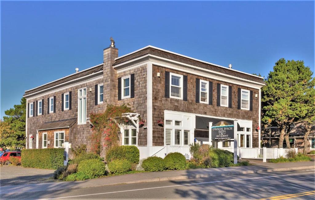 a large brick building with a sign in front of it at Cannon Beach Hotel Collection in Cannon Beach