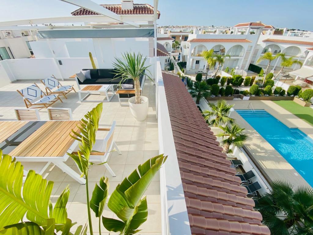 an apartment with a swimming pool on the roof of a building at Fortuna Penthouse with roof terrace, AC and pool in Rojales