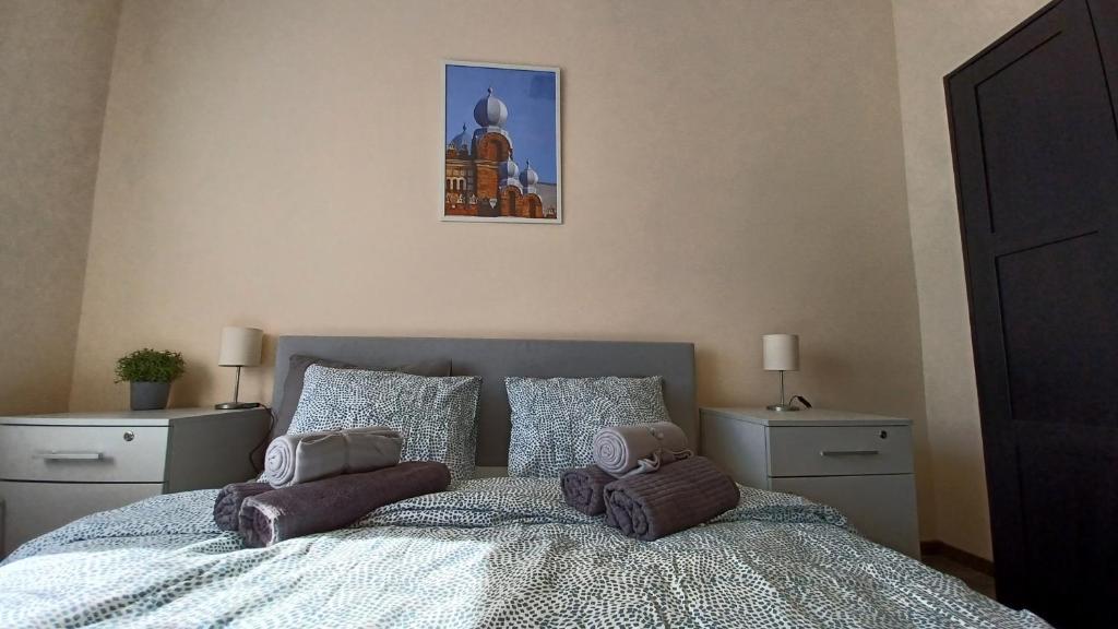 A bed or beds in a room at Savaria Apartment Szombathely