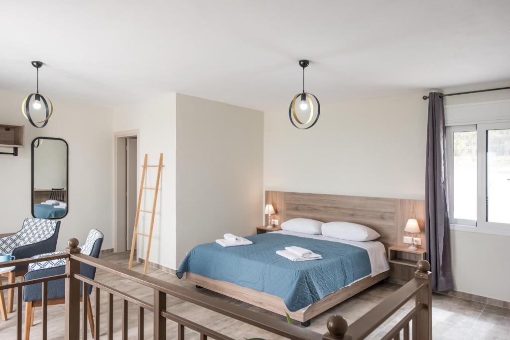 a bedroom with a bed and a desk and a mirror at Dina's cottage,near balos and elafonisi in Kaloudhianá