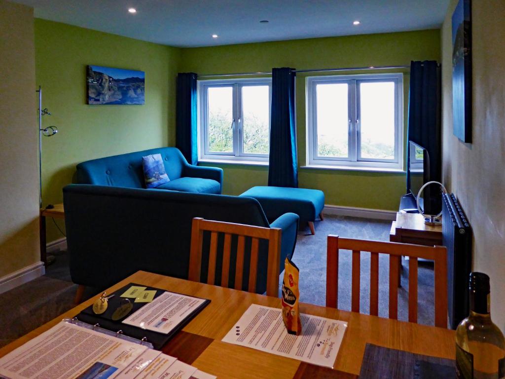 a living room with a table and a couch at Bryn Melyn Apartments in Barmouth