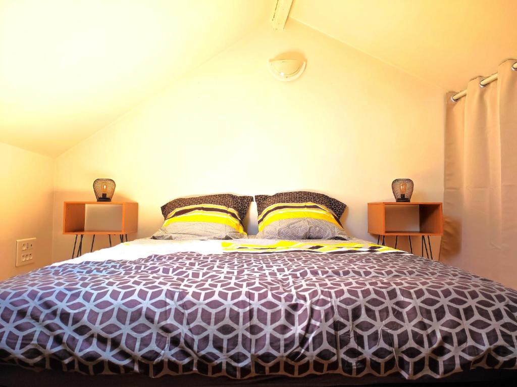 a bedroom with a purple bed with two night stands at Le 3plex - Coeur de Vertou - Original in Vertou
