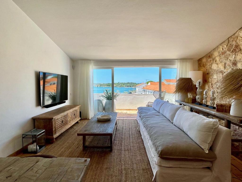 a living room with a large couch and a large window at Alvor Bela Vista I in Alvor