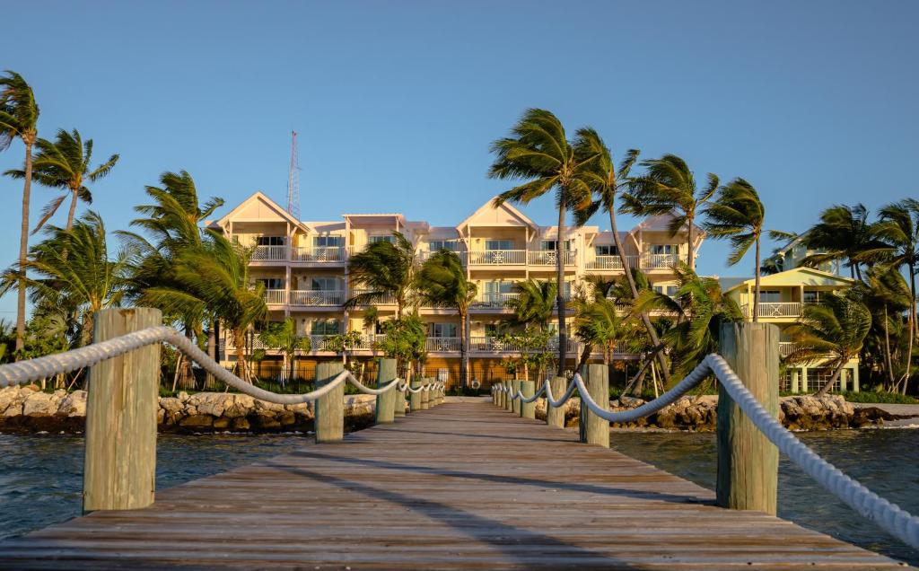 a wooden bridge leading to a resort on the water at Grassy Flats Resort & Beach Club in Marathon