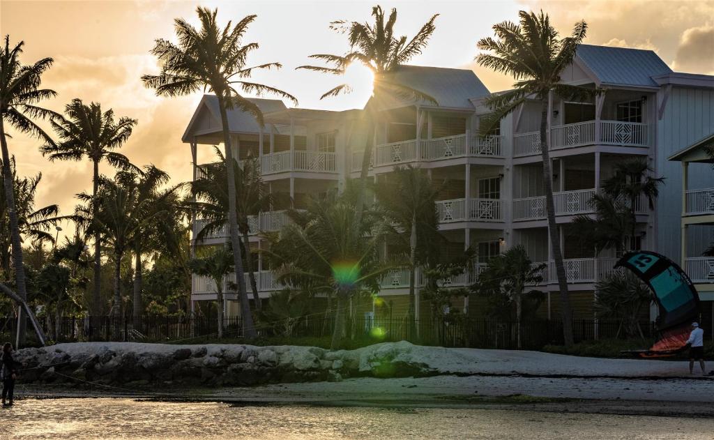 a building on the beach with a kite in front of it at Grassy Flats Resort & Beach Club in Marathon