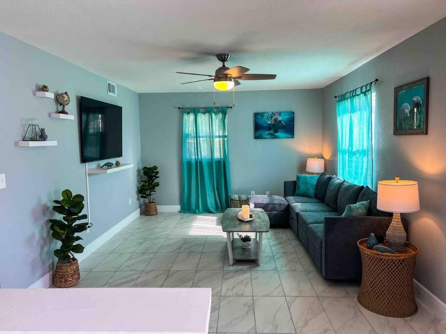 a living room with a couch and a table at House of Manatees-Entire house with yard, fire pit, dog friendly in Crystal River