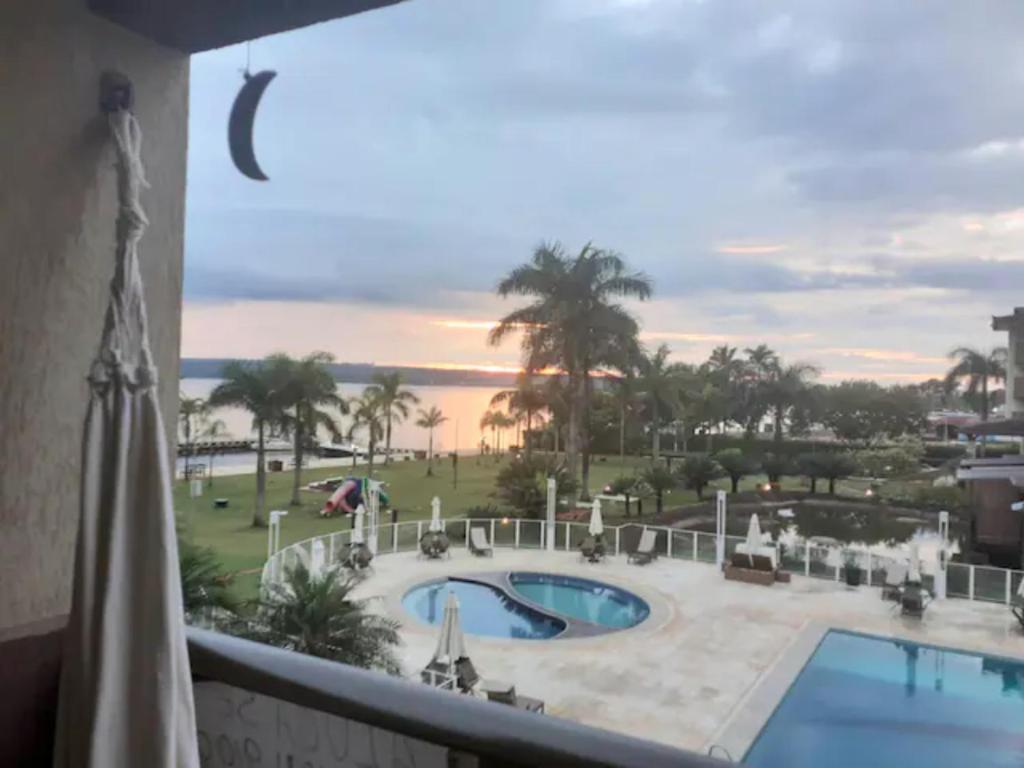 a view of the pool from the balcony of a resort at Life Resort energizante com vista encantadora do lago in Brasilia