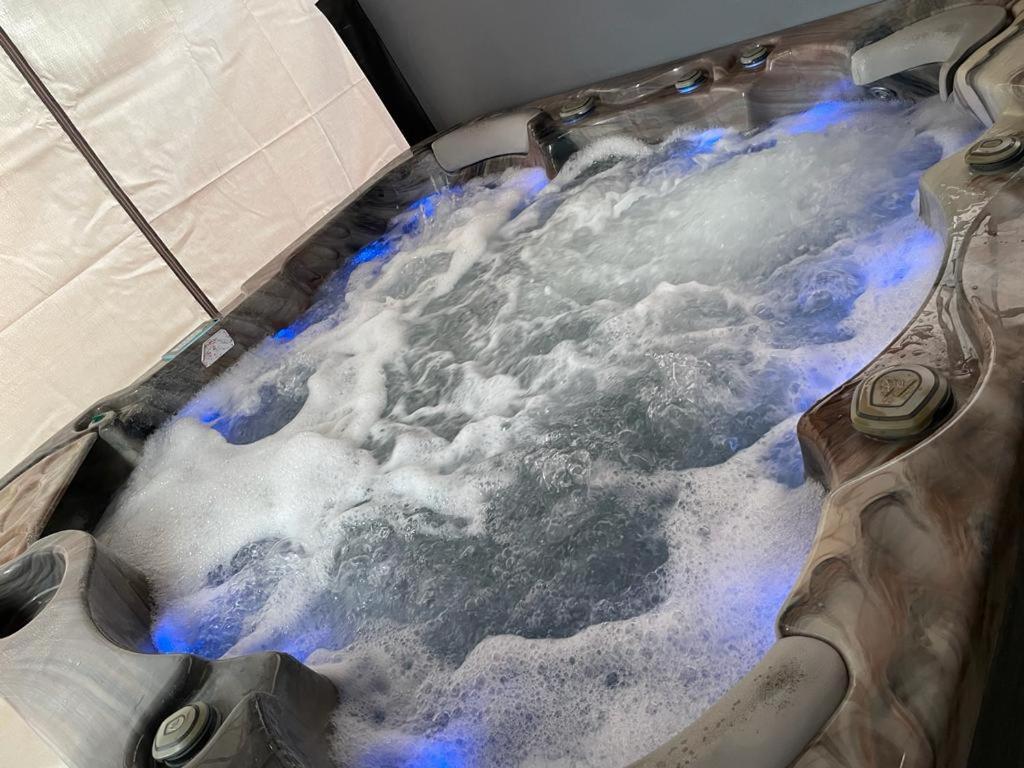 a hot tub with snow and ice on the floor at Travel Legend Stays 1 or 2 bedroom place with Hot Tub in Farnham Royal